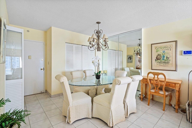 dining space featuring light tile patterned floors, a textured ceiling, and a chandelier