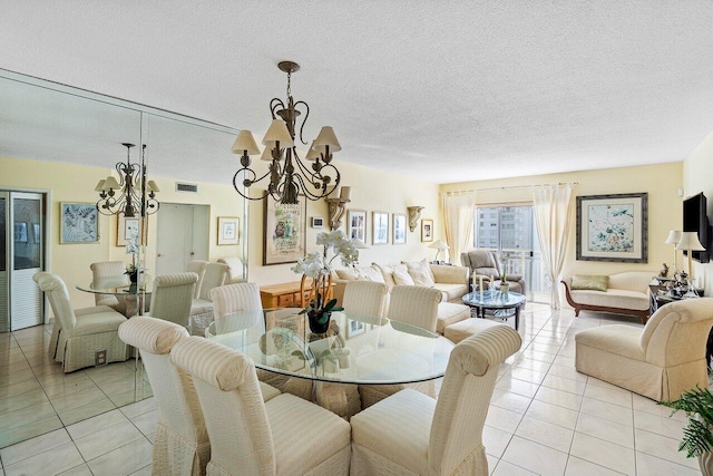 dining area featuring a notable chandelier, light tile patterned floors, and a textured ceiling