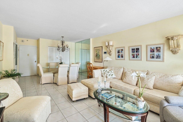 living room featuring light tile patterned floors, a textured ceiling, and an inviting chandelier