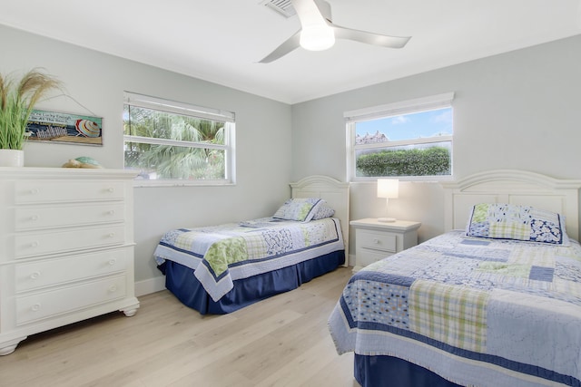 bedroom featuring light hardwood / wood-style floors and ceiling fan