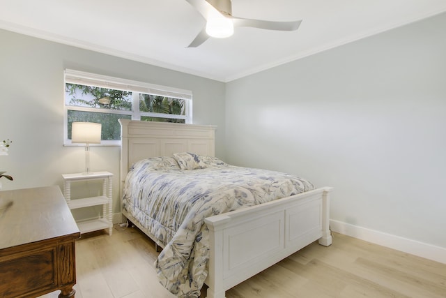 bedroom featuring ceiling fan, crown molding, and light hardwood / wood-style flooring