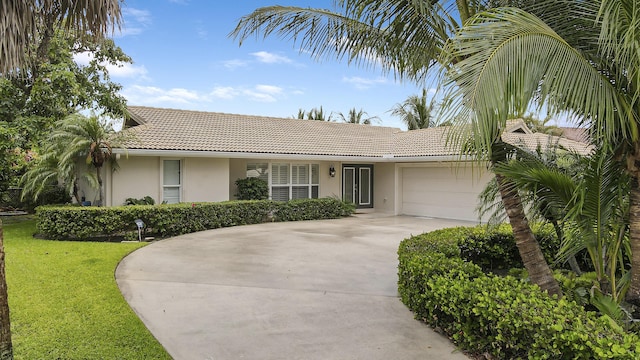 single story home with a garage and a front lawn