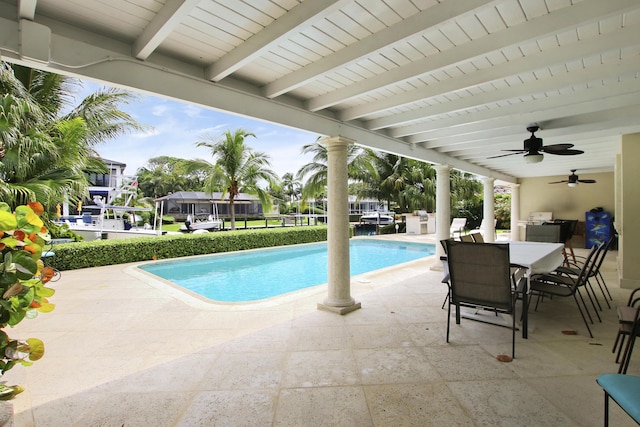 view of swimming pool featuring ceiling fan and a patio area