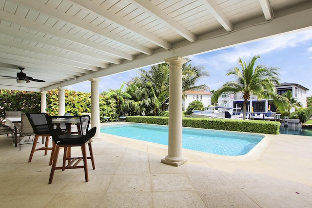 view of swimming pool featuring ceiling fan and a patio area