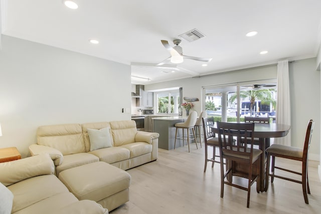 living room featuring ceiling fan and light hardwood / wood-style floors