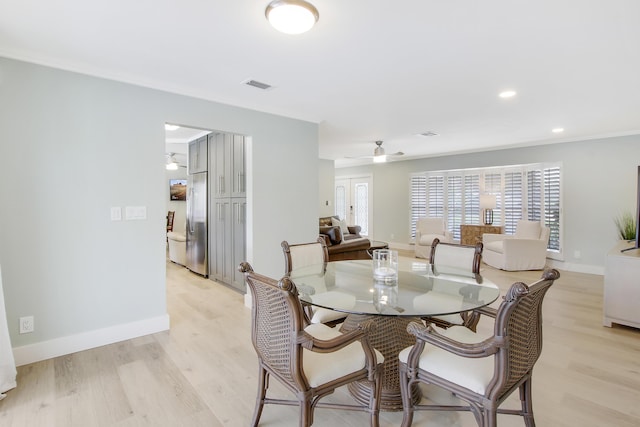 dining room with ceiling fan and light wood-type flooring