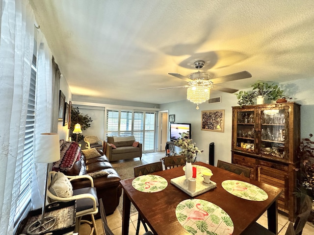 dining area with tile patterned floors and ceiling fan