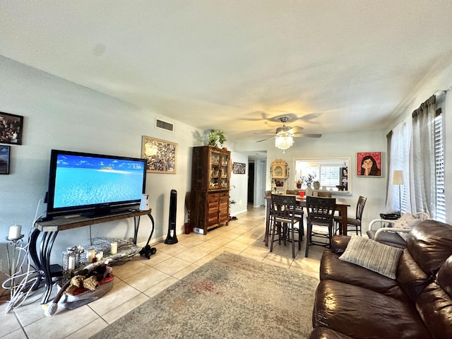 living room featuring ceiling fan and light tile patterned floors