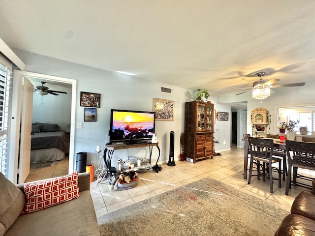 living room featuring ceiling fan and light tile patterned floors