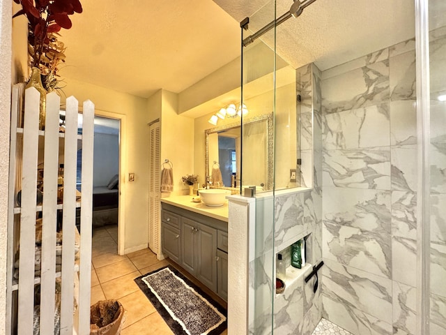 bathroom featuring an inviting chandelier, walk in shower, tile patterned floors, a textured ceiling, and vanity