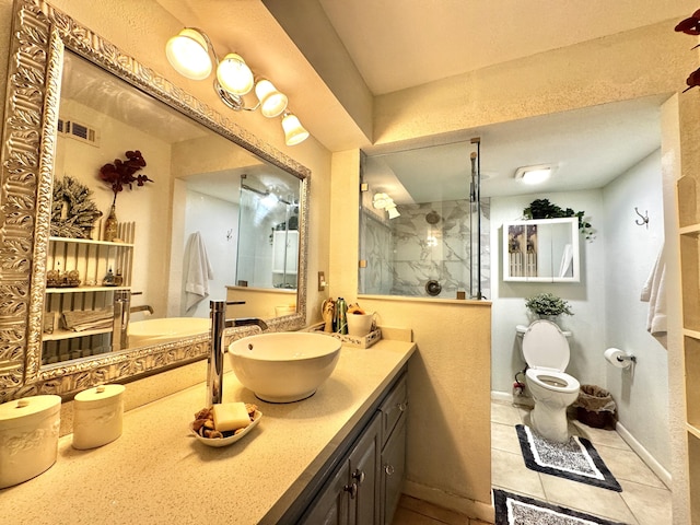 bathroom with a tile shower, vanity, and toilet