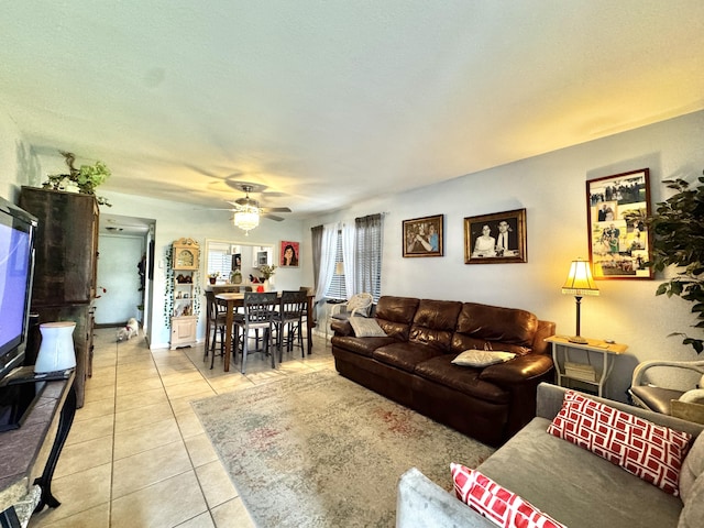 living room featuring ceiling fan and light tile patterned flooring