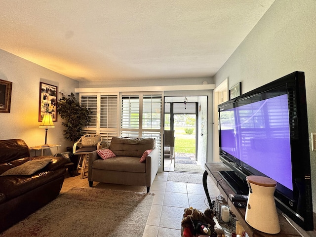 living room with a textured ceiling and light tile patterned flooring