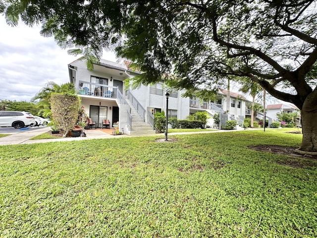 view of front of house with a patio area and a front lawn