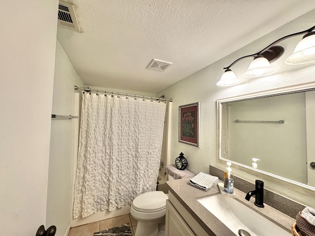 full bathroom featuring vanity, tile patterned floors, toilet, a textured ceiling, and shower / tub combo