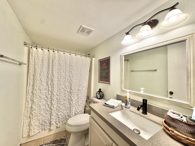 full bathroom with tile patterned floors, vanity, a textured ceiling, shower / bath combo with shower curtain, and toilet