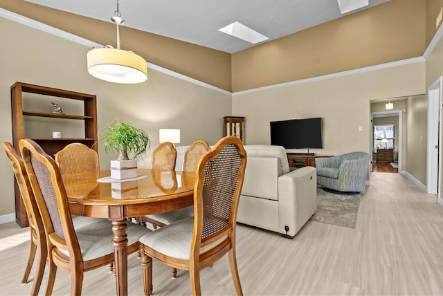 dining area featuring light hardwood / wood-style floors and a skylight