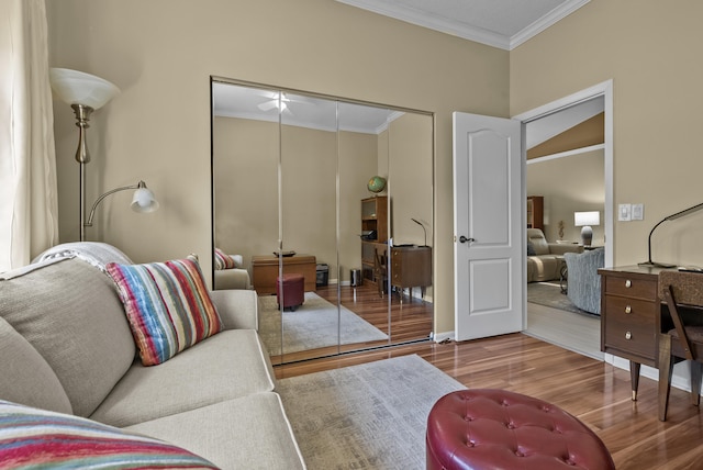 living room featuring wood-type flooring and crown molding