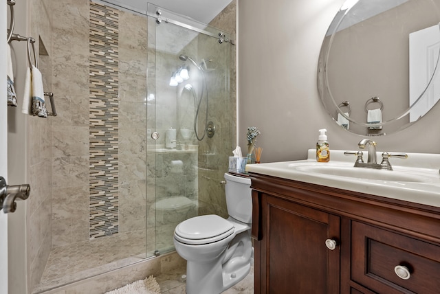 bathroom with vanity, toilet, and a shower with shower door