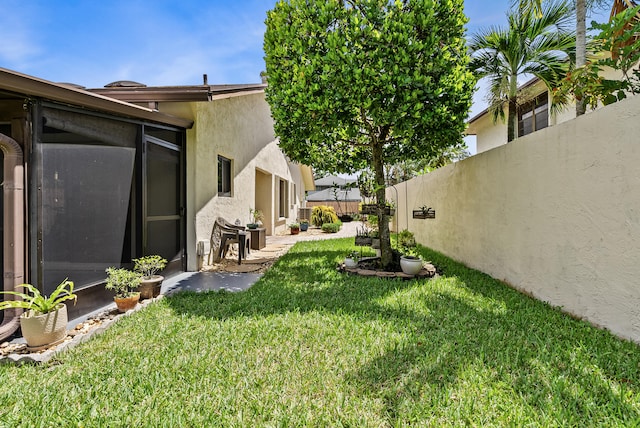 view of yard with a sunroom