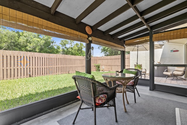 sunroom / solarium featuring lofted ceiling