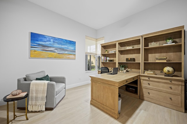 office space featuring light wood-style floors and baseboards