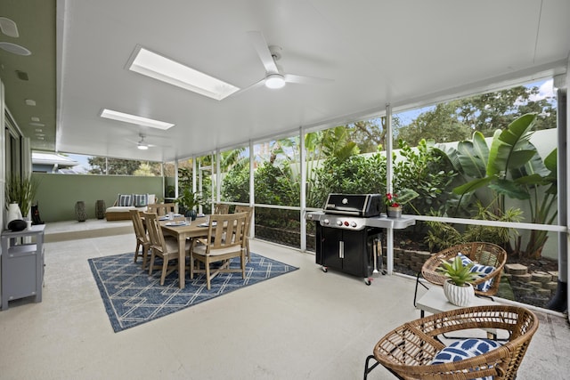 sunroom featuring a skylight and ceiling fan