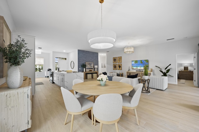 dining space with light hardwood / wood-style floors