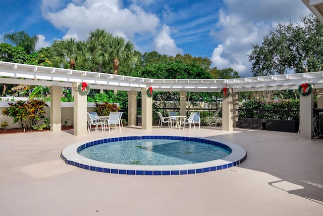 view of swimming pool featuring a patio area, fence, a swimming pool, and a pergola