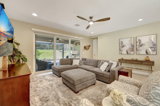 living room with ceiling fan and light tile patterned floors