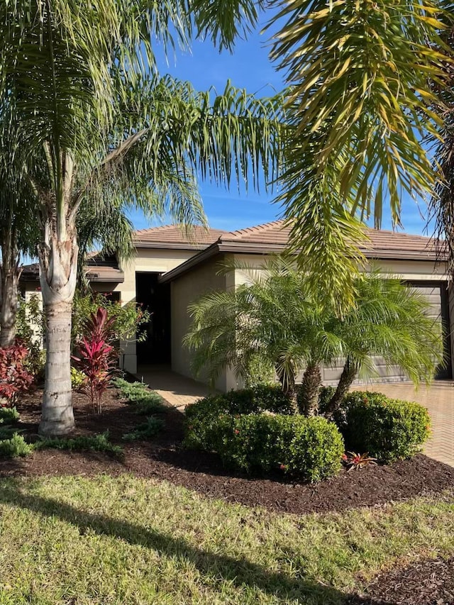 view of property exterior with a tiled roof and stucco siding