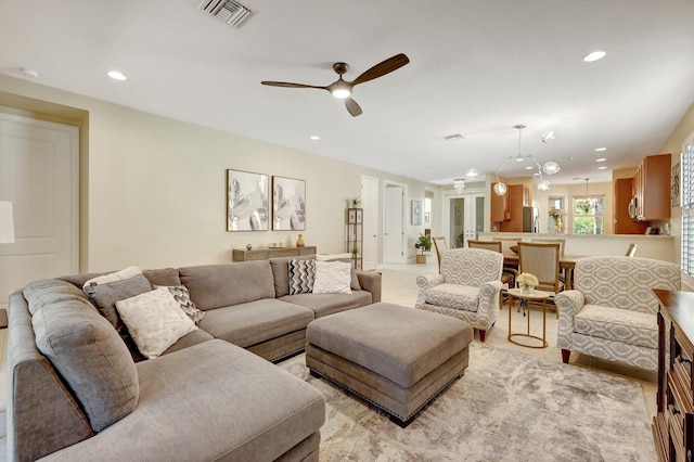 living room featuring ceiling fan and french doors