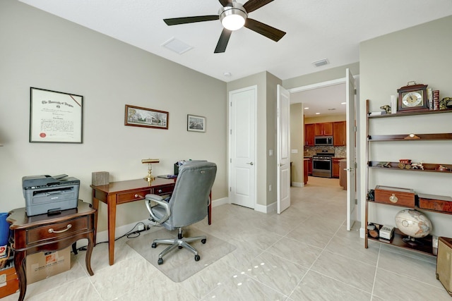 home office with light tile patterned floors and ceiling fan