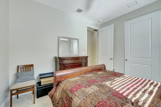 bedroom with ceiling fan and light tile patterned floors