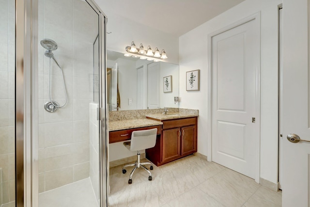 bathroom with a shower with door and vanity