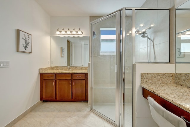 bathroom featuring vanity and a shower with shower door