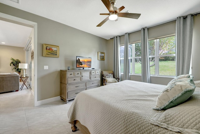 tiled bedroom with ceiling fan