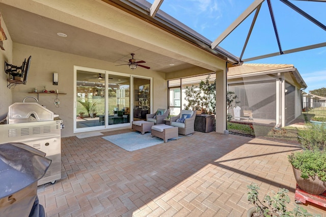 view of patio / terrace featuring outdoor lounge area, ceiling fan, and a lanai