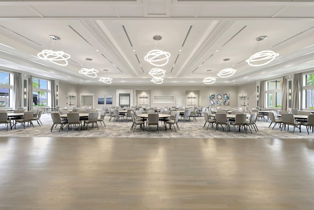 unfurnished dining area featuring a tray ceiling, light hardwood / wood-style flooring, and plenty of natural light