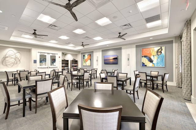 carpeted dining room featuring a paneled ceiling and a tray ceiling