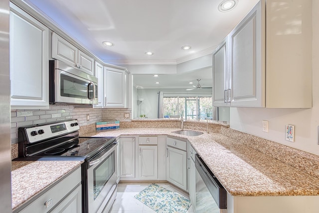 kitchen with ornamental molding, stainless steel appliances, ceiling fan, sink, and light tile patterned floors