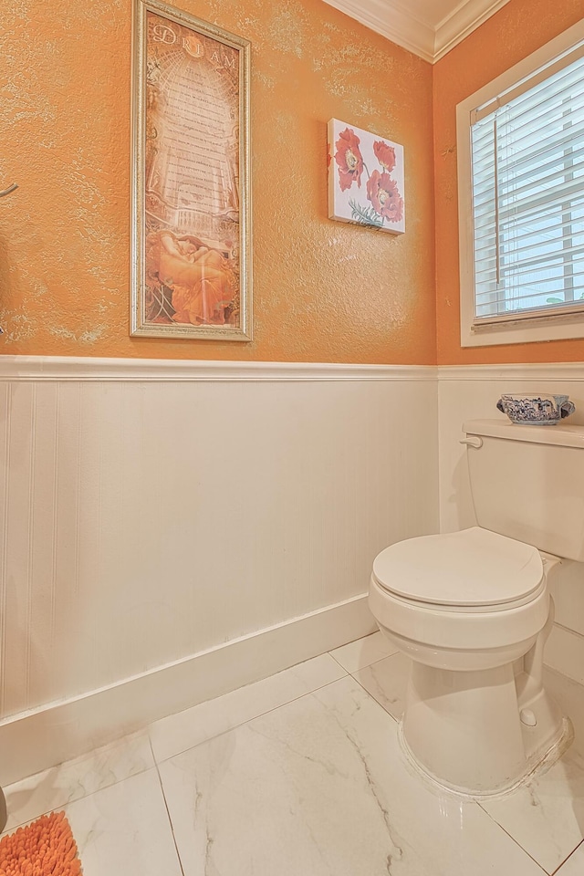 bathroom with toilet and crown molding