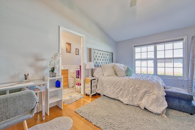 bedroom featuring lofted ceiling and hardwood / wood-style flooring