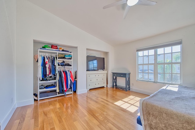 bedroom featuring ceiling fan, light hardwood / wood-style floors, vaulted ceiling, and a closet