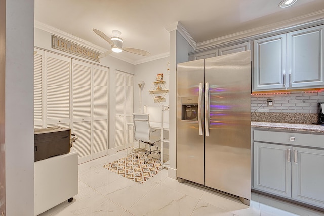 kitchen with stainless steel refrigerator with ice dispenser, ornamental molding, ceiling fan, and gray cabinetry