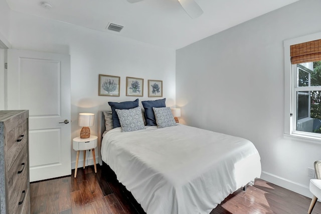 bedroom with ceiling fan and dark hardwood / wood-style flooring