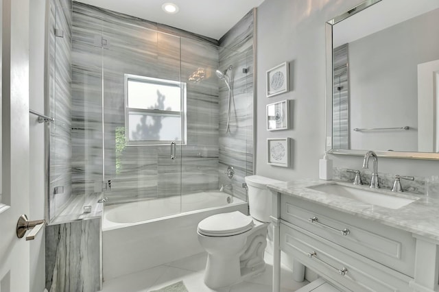 full bathroom with tile patterned flooring, vanity, toilet, and bath / shower combo with glass door