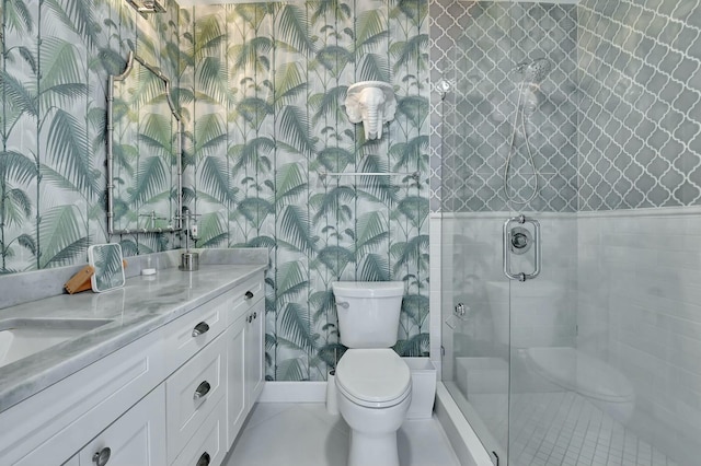 bathroom with vanity, toilet, and a shower with door