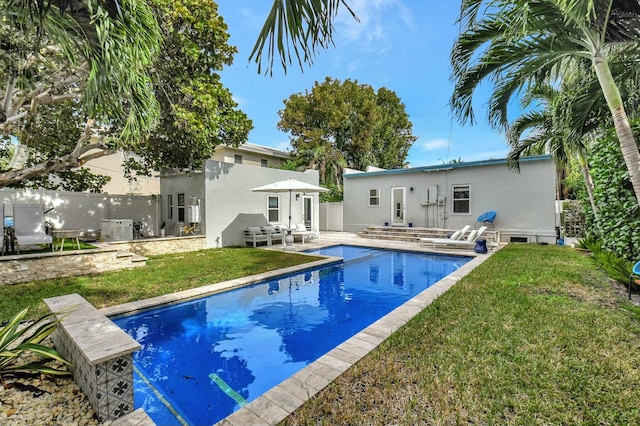 rear view of house with a patio area and a yard