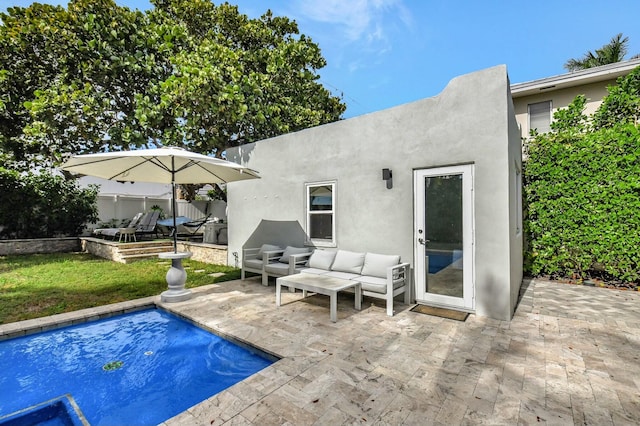 view of pool with an outdoor living space and a patio